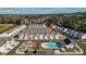 Aerial view of the community featuring townhomes, parking, pool, and green space at 2128 Cosette Ln, Kennesaw, GA 30152