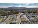 Scenic aerial view of a residential neighborhood featuring a pool, clubhouse, and mountain views in the background at 2128 Cosette Ln, Kennesaw, GA 30152