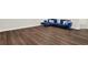 Stylish basement featuring beautiful wood-look flooring and a comfortable blue velvet sofa at 2128 Cosette Ln, Kennesaw, GA 30152