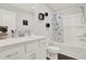 Well-lit bathroom features modern fixtures, a bathtub with a shower, and unique wall decor at 2128 Cosette Ln, Kennesaw, GA 30152
