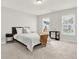 Bright bedroom with neutral walls, plush carpet, and two windows offering natural light at 2128 Cosette Ln, Kennesaw, GA 30152