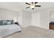 Bedroom featuring a ceiling fan, carpet flooring, closet, and a nightstand with a lamp at 2128 Cosette Ln, Kennesaw, GA 30152