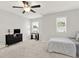 Bright bedroom with a ceiling fan, carpet flooring, two windows, and a TV at 2128 Cosette Ln, Kennesaw, GA 30152