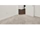Close up of a room featuring white walls, carpet flooring and an open door to the wood floor at 2128 Cosette Ln, Kennesaw, GA 30152