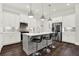 Modern kitchen features a center island with bar seating, stainless steel appliances, and ample cabinet space at 2128 Cosette Ln, Kennesaw, GA 30152