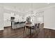 Open-concept kitchen and dining area boasts stainless steel appliances, a gray island, and stylish pendant lighting at 2128 Cosette Ln, Kennesaw, GA 30152