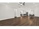 Open-concept living room with hardwood floors connects to a kitchen and dining area, creating a spacious feel at 2128 Cosette Ln, Kennesaw, GA 30152