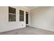Covered back patio featuring two windows and access door to the back of the home at 2128 Cosette Ln, Kennesaw, GA 30152