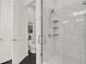 Modern tiled shower with glass door and built-in shelving, adjacent to separate toilet at 2128 Cosette Ln, Kennesaw, GA 30152