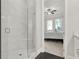 Beautiful shower with glass door leads to a bedroom with a ceiling fan and two windows at 2128 Cosette Ln, Kennesaw, GA 30152