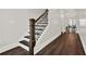 Elegant staircase with hardwood steps, decorative railing, and freshly painted walls in the foyer at 2128 Cosette Ln, Kennesaw, GA 30152