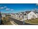 Wide view of street featuring new construction gray townhomes with attached garages and well maintained landscaping at 2128 Cosette Ln, Kennesaw, GA 30152