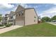 Charming side view of a tan two-story home with green lawn at 3137 Spicy Cedar Ln, Stonecrest, GA 30038