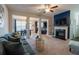 Comfortable living room featuring fireplace, TV, and open to dining area at 3137 Spicy Cedar Ln, Stonecrest, GA 30038