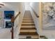 Classic wood staircase with white risers and views into the living room at 3137 Spicy Cedar Ln, Stonecrest, GA 30038