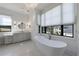 Luxury bathroom with modern tub, double vanity sinks, and natural light at 835 Kenry Ct, Atlanta, GA 30342