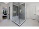 Modern bathroom with a glass-enclosed shower featuring gray tile and a built-in bench at 835 Kenry Ct, Atlanta, GA 30342