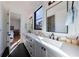 Stylish bathroom featuring a double vanity, elegant fixtures, and sleek black hexagon tile flooring at 835 Kenry Ct, Atlanta, GA 30342