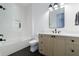 Bathroom featuring a white subway tile shower, gray vanity, and black fixtures at 835 Kenry Ct, Atlanta, GA 30342