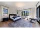 Primary bedroom with hardwood floors, large windows, and stylish decor at 835 Kenry Ct, Atlanta, GA 30342