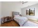 Bright bedroom with a plush bed, accent pillows, hardwood floors and large black trim windows at 835 Kenry Ct, Atlanta, GA 30342