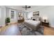 Well-lit primary bedroom with area rug, ceiling fan, and large windows at 835 Kenry Ct, Atlanta, GA 30342