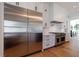 This kitchen has stainless steel appliances, white cabinets, and hardwood floors at 835 Kenry Ct, Atlanta, GA 30342