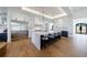 Open kitchen with a large island, modern appliances, white cabinets and wood flooring at 835 Kenry Ct, Atlanta, GA 30342