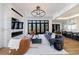 Open-concept living room with fireplace, large windows, and seamless flow to kitchen at 835 Kenry Ct, Atlanta, GA 30342