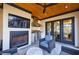 Back porch with fireplace, stainless grill, and patio chairs at 835 Kenry Ct, Atlanta, GA 30342