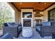 Inviting outdoor patio with fireplace, grill, and comfortable seating area at 835 Kenry Ct, Atlanta, GA 30342