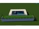This in-ground pool features a concrete deck, with an adjacent green patio area, all surrounded by a grass yard at 835 Kenry Ct, Atlanta, GA 30342