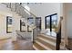 Bright foyer with stylish staircase featuring wood treads, black metal railings, and many windows at 835 Kenry Ct, Atlanta, GA 30342