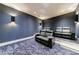 Home theater room featuring tiered seating and ambient lighting at 835 Kenry Ct, Atlanta, GA 30342