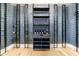 Custom wine cellar with gray shelving, wine rack and wood flooring at 835 Kenry Ct, Atlanta, GA 30342