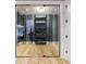 Contemporary wine cellar with glass doors and custom shelving at 835 Kenry Ct, Atlanta, GA 30342
