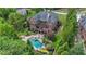 Backyard featuring a large pool, spa, and an outdoor seating area with lush landscaping at 1391 Harris Rd, Lawrenceville, GA 30043