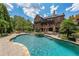 Beautiful backyard showcasing a large pool, hot tub, mature landscaping, and an inviting outdoor space at 1391 Harris Rd, Lawrenceville, GA 30043
