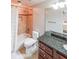 Well-lit bathroom featuring a granite countertop, dark wood cabinets and tile shower at 1391 Harris Rd, Lawrenceville, GA 30043