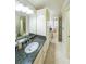 Bright bathroom showcasing a granite countertop, neutral tile flooring, and a shower/tub combo at 1391 Harris Rd, Lawrenceville, GA 30043