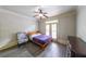 Bright bedroom with a comfortable bed, hardwood floors, ceiling fan, and closet space at 1391 Harris Rd, Lawrenceville, GA 30043
