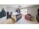 Spacious bedroom with a ceiling fan, chair, and shuttered windows allowing natural light at 1391 Harris Rd, Lawrenceville, GA 30043