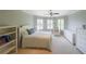 Bright bedroom features a cozy bed, large windows, and a sitting area at 1391 Harris Rd, Lawrenceville, GA 30043