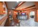Dining room with wood beam accents, brick walls, a fish tank and a bar at 1391 Harris Rd, Lawrenceville, GA 30043
