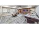 Spacious game room featuring an air hockey table, carpet, natural light and fish tank at 1391 Harris Rd, Lawrenceville, GA 30043