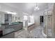 Main bathroom with dual sinks, granite counters, walk-in shower, vaulted ceiling, and soaking tub at 1391 Harris Rd, Lawrenceville, GA 30043