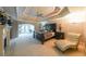 Spacious main bedroom with tray ceilings, a ceiling fan, a fireplace, and an adjoining sitting area with French doors at 1391 Harris Rd, Lawrenceville, GA 30043