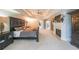 Large main bedroom featuring tray ceilings, a ceiling fan, a fireplace and adjacent black furniture at 1391 Harris Rd, Lawrenceville, GA 30043