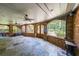 Large covered patio with brick arches, ceiling fans, and stone floors offering an outdoor living space at 1391 Harris Rd, Lawrenceville, GA 30043