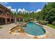 Expansive backyard features a luxurious pool, hot tub, waterslide, and lush landscaping for outdoor enjoyment at 1391 Harris Rd, Lawrenceville, GA 30043